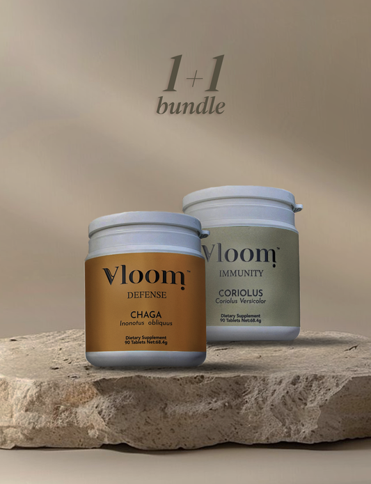 Two Vloom supplement jars on a stone surface with a beige background