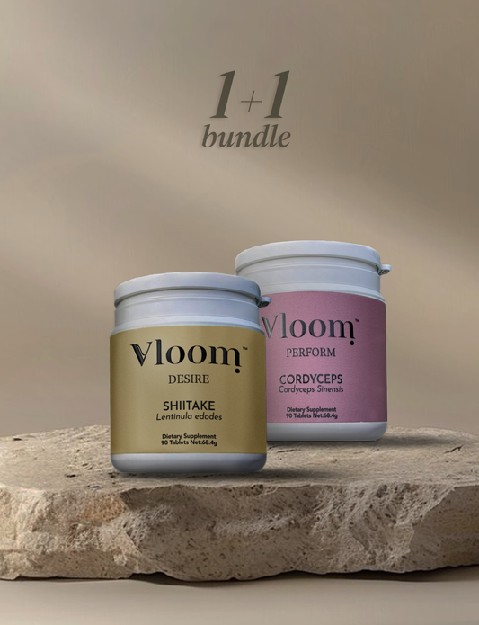 Two Vloom supplement jars on a stone surface with a beige background