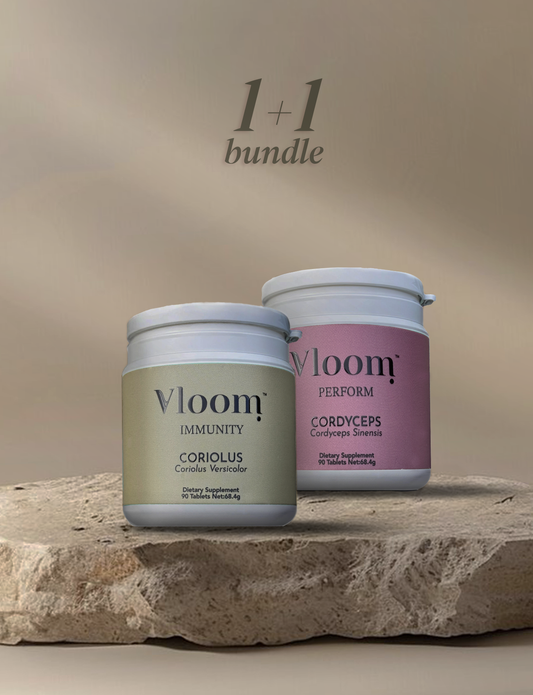 Two Vloom supplement jars on a stone surface with a beige background, Turkey Tail, cordyceps