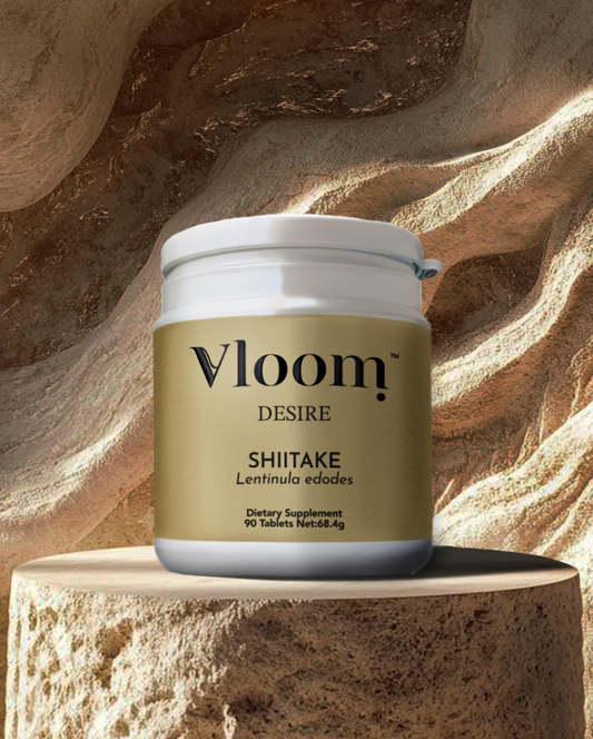 Vloom Desire Shiitake dietary supplement jar on a stone surface with a stone background